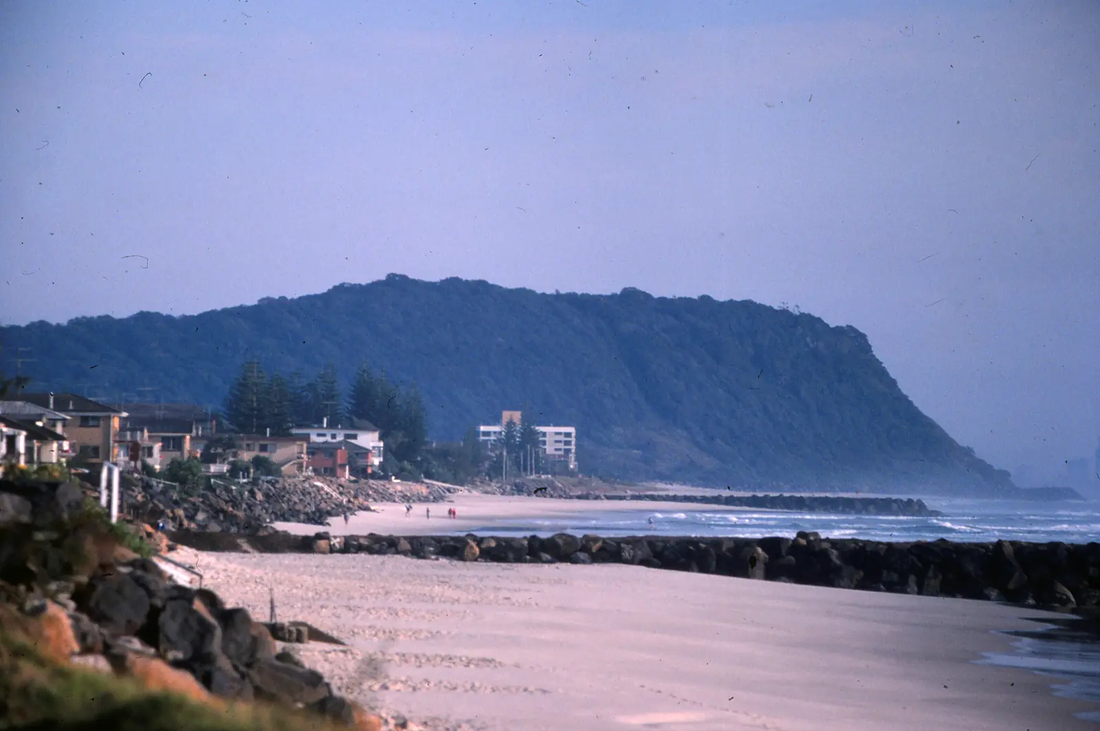 View from Palm Beach Surf Life Saving Club on Jefferson Lane toward Burleigh Head, with the beach and buildings of Palm Beach in between.